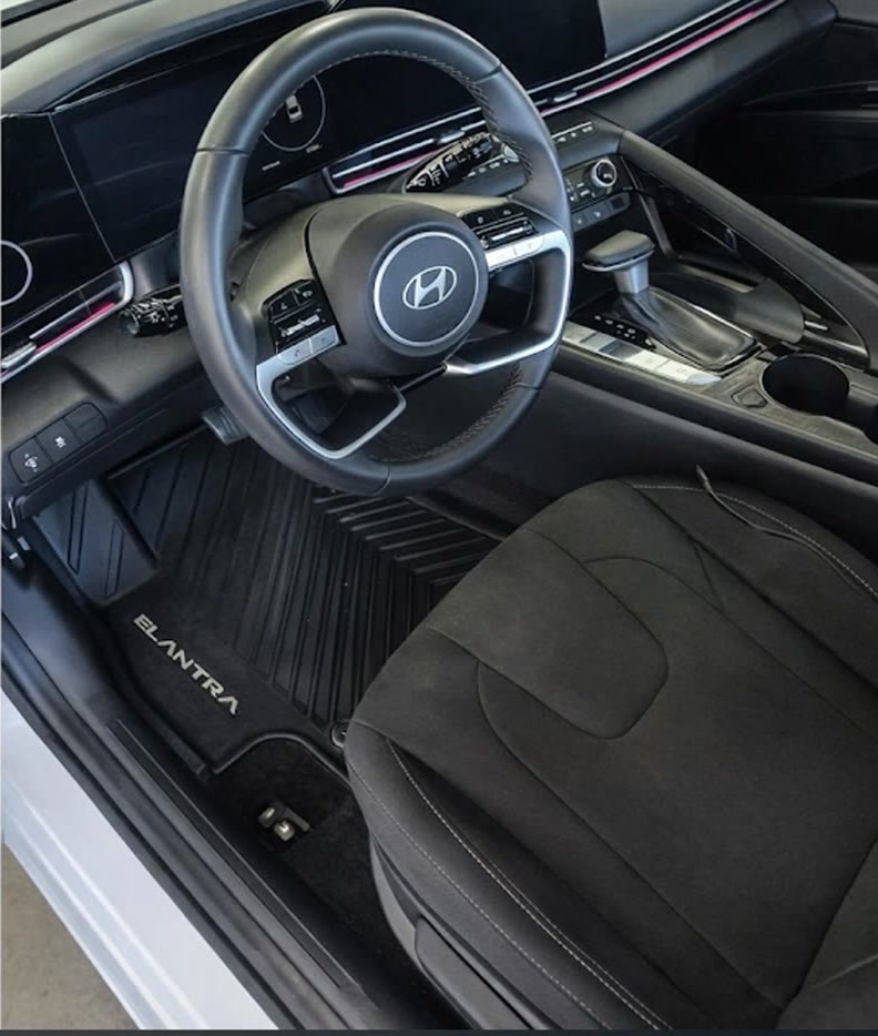 The same Hyundai Elantra interior after detailing — clean mats, carpet, dash and seats