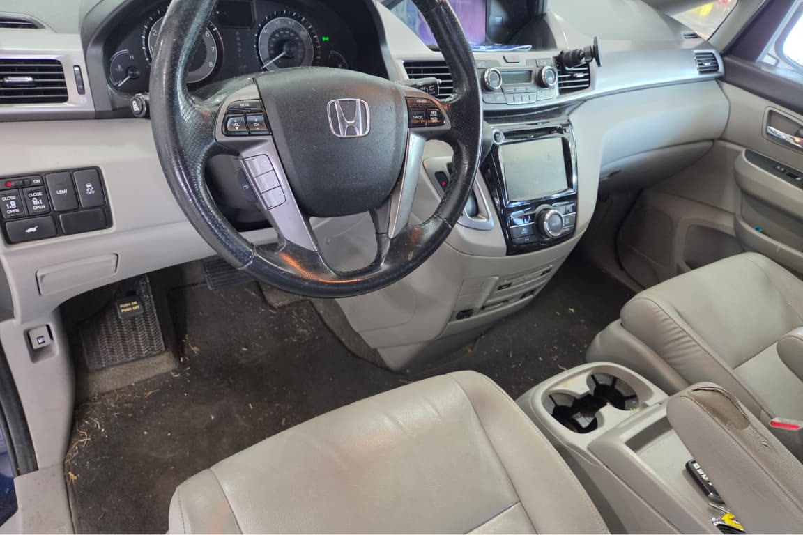 A Honda Odyssey interior before a full detail — stained carpet and dirty upholstery