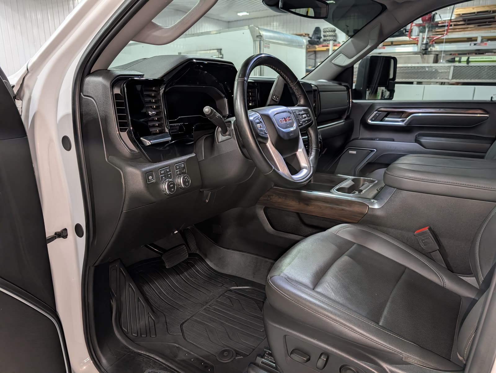 The cleaned front interior of a GMC Sierra, showing the dash, steering wheel and leather seats