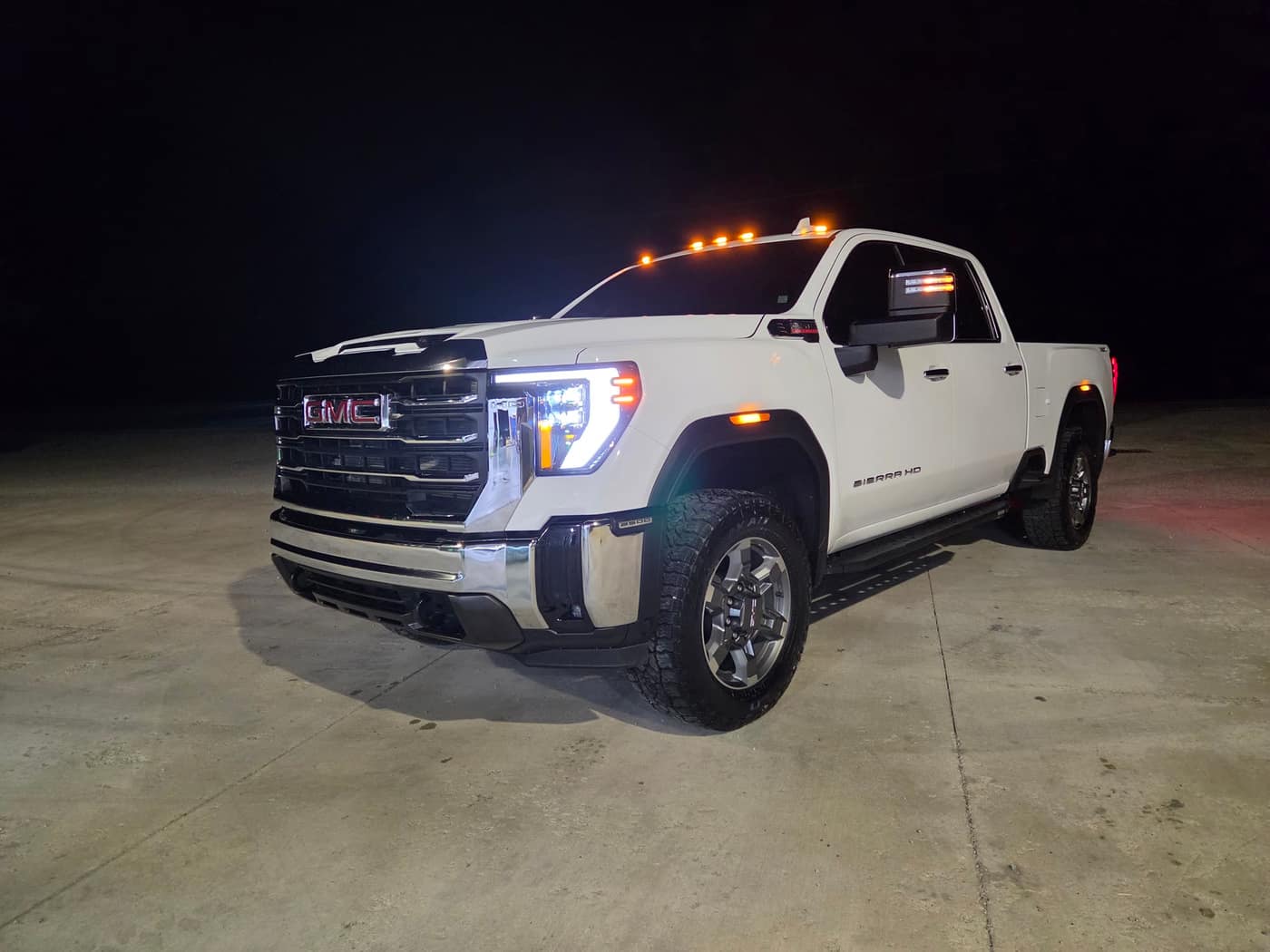 A white GMC Sierra pickup washed and detailed, photographed at night outside the shop in Leesburg, Ohio