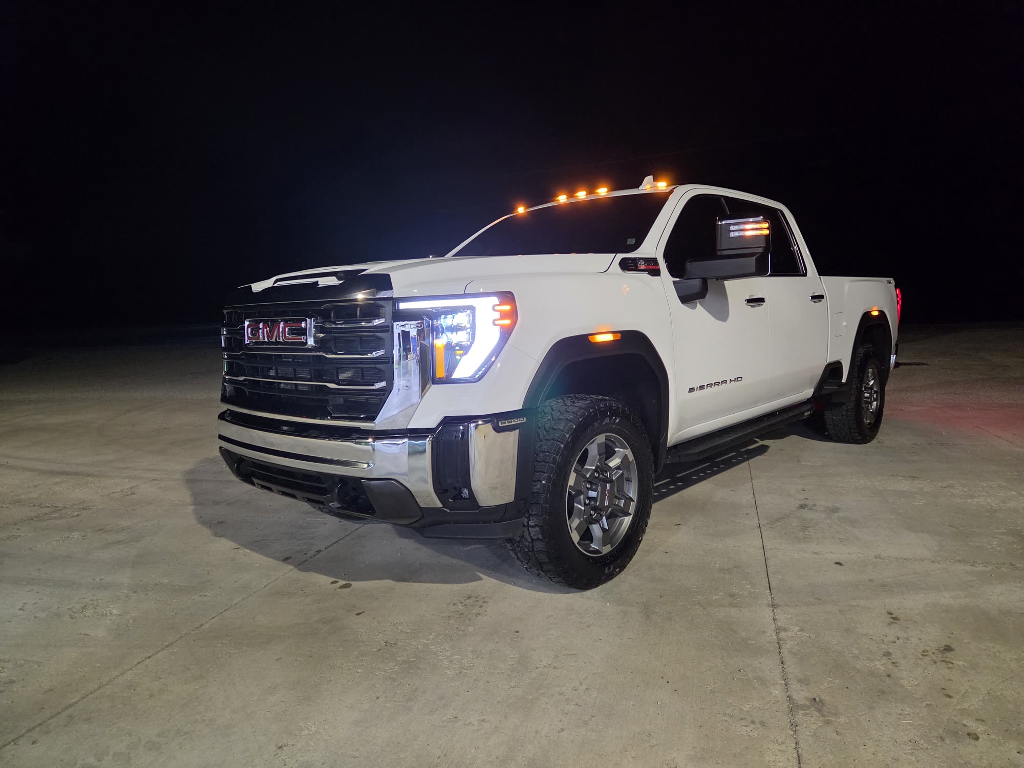 A white GMC Sierra pickup washed and detailed, photographed at night outside the shop in Leesburg, Ohio