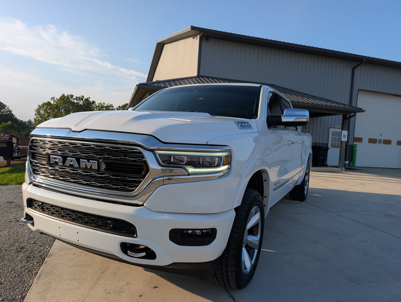 A ceramic coated white RAM 1500 Limited outside the Signature Auto Detailing shop in Leesburg, Ohio, the coated paint holding a deep gloss in evening sun