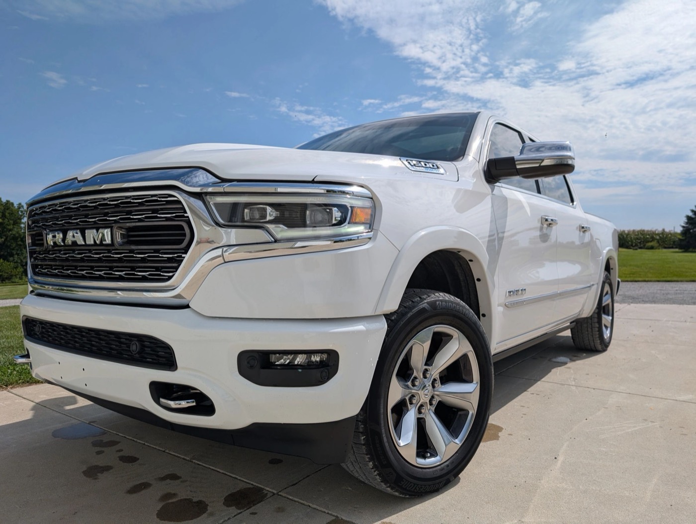 A white RAM 1500 outside on a clear day after an exterior detail